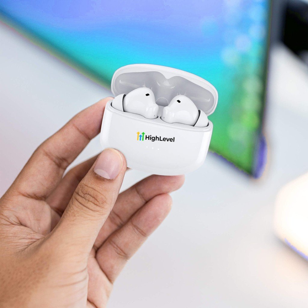 White wireless earbuds in an open charging case with a logo on the lid